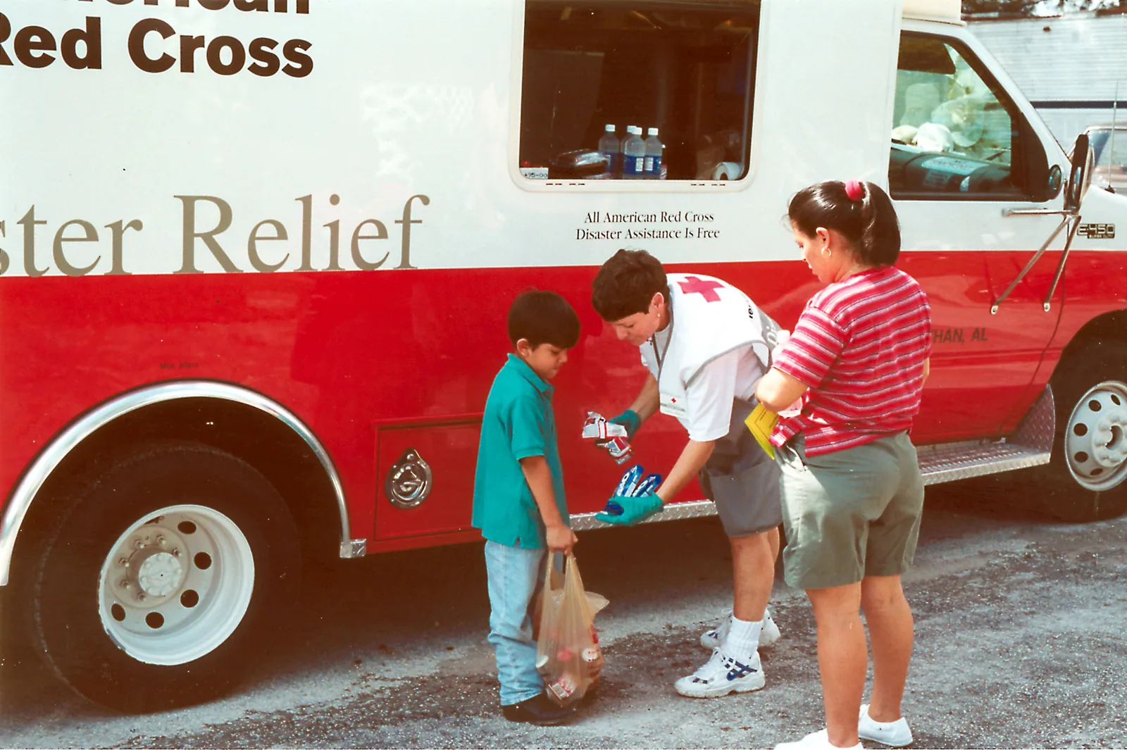 A Red Cross worker hands out food and water to flood victims in Pembroke Pines after heavy rain in October 2000.