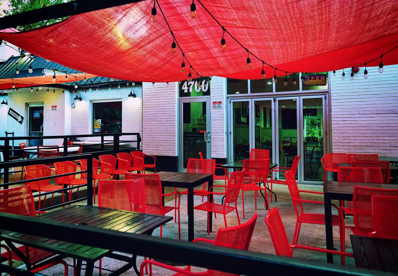 Tables and umbrellas at a sidewalk cafe. The photo was not taken in Pembroke Pines.