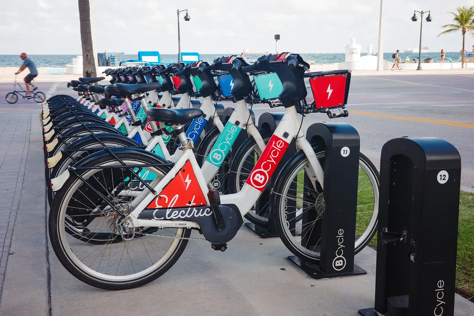 Rental electric bikes in a docking station by the beach in Fort Lauderdale.